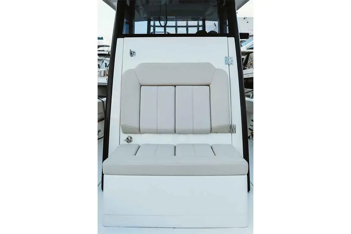 Boat seating with light grey cushions, set against a white backdrop, showcasing a sleek marine design.